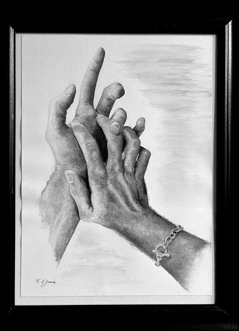 Framed gouache painting of two clasped hands, one wrist wearing a fine chain bracelet.